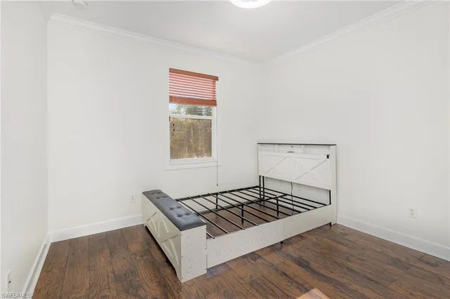 a living room with wooden floor and a window