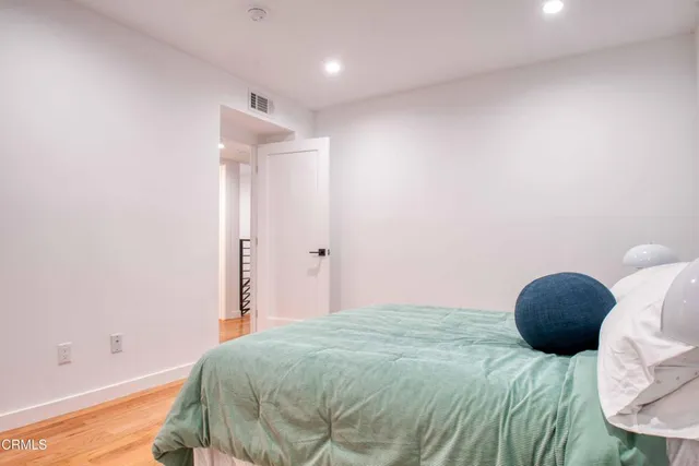 a bedroom with a bed and a lamp