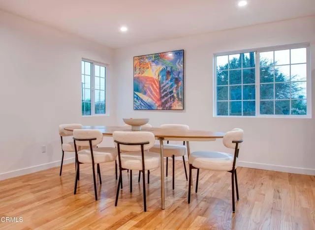 a view of a dining room with furniture and wooden floor