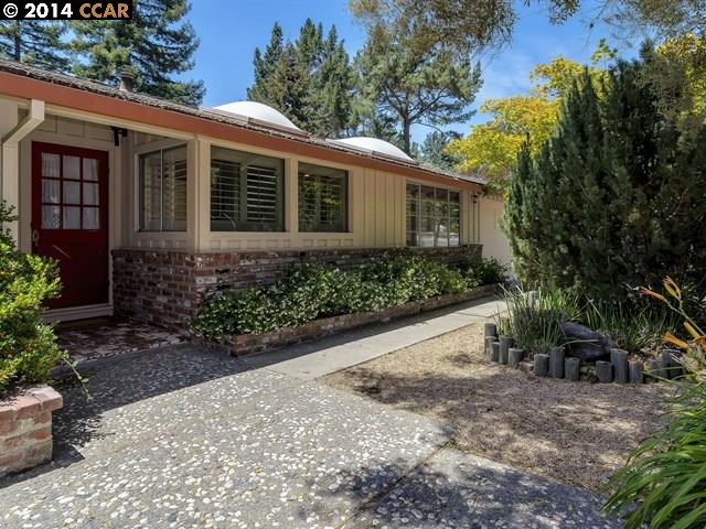 a view of a house with a yard and plants