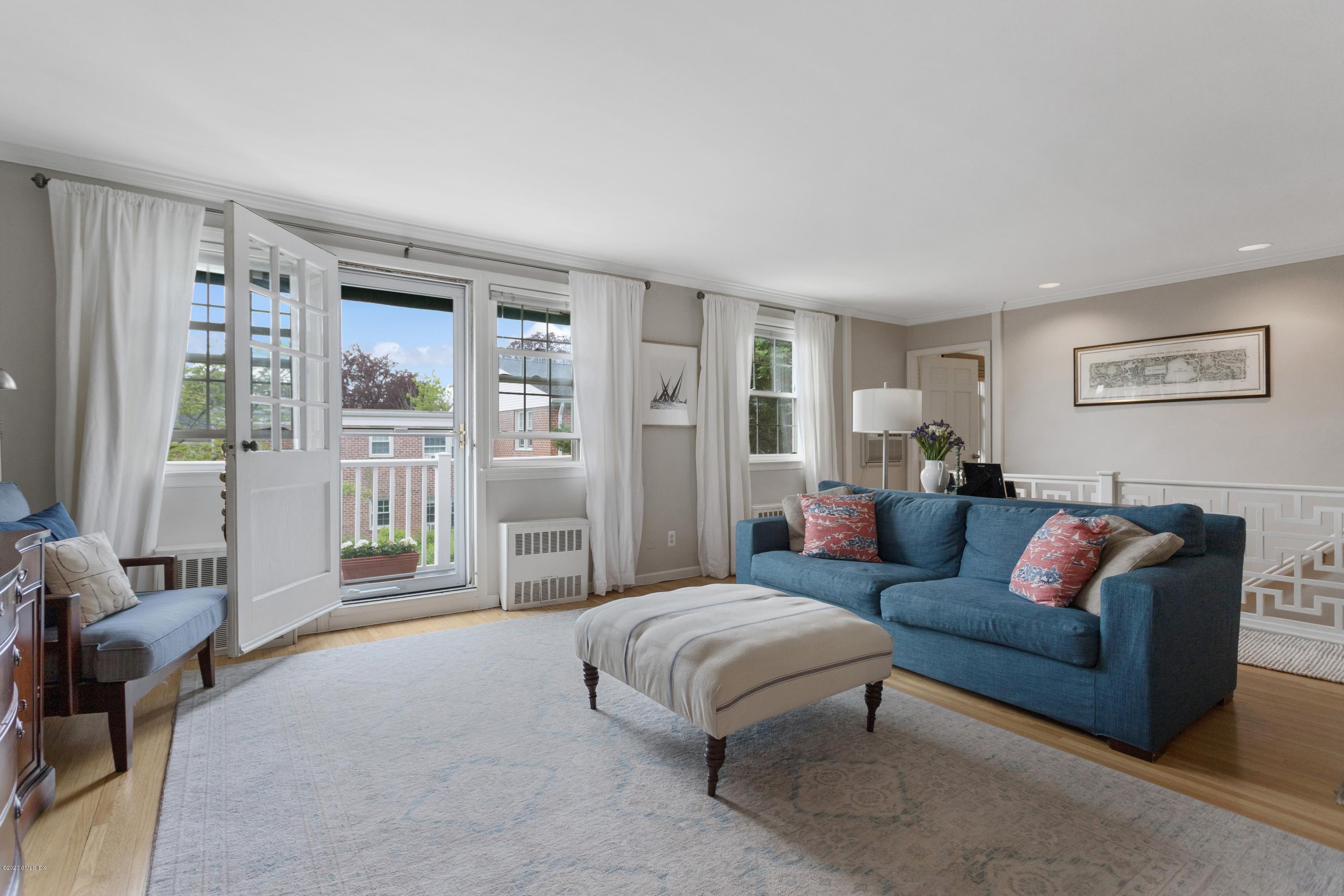 100 Putnam Park, Unit 100 Greenwich, CT 06830 - Photo 1 of 15 a living room with furniture and a large window