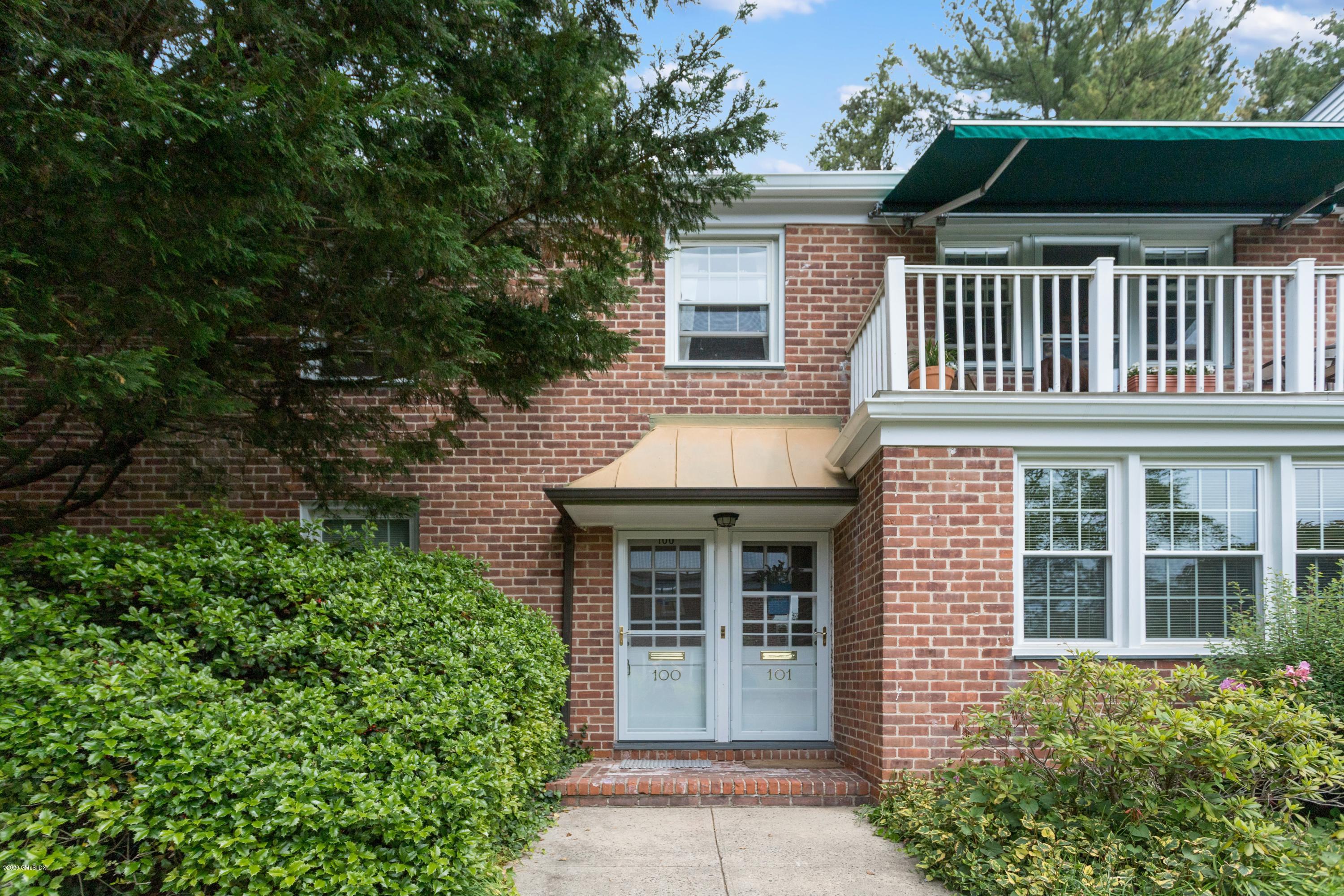 100 Putnam Park, Unit 100 Greenwich, CT 06830 - Photo 12 of 15 a front view of a house with a garden