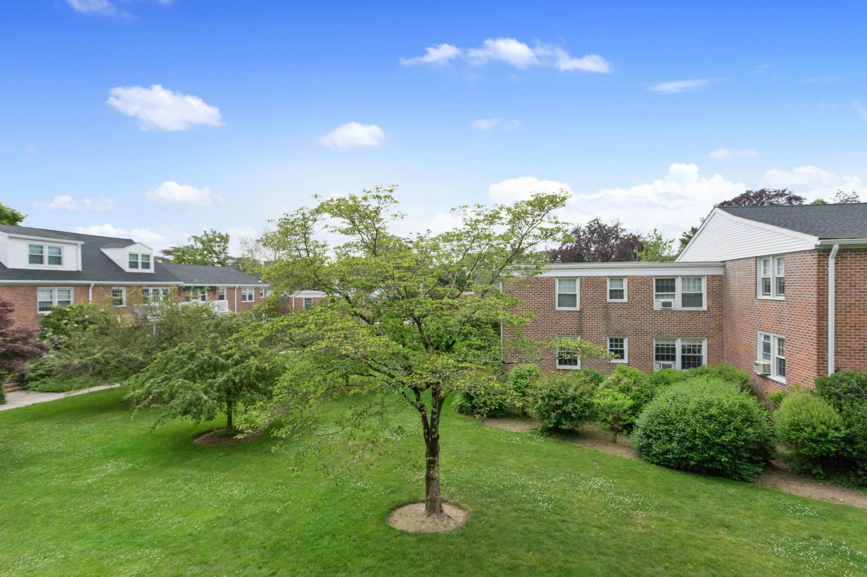 100 Putnam Park, Unit 100 Greenwich, CT 06830 - Photo 14 of 15 a front view of a house with a yard