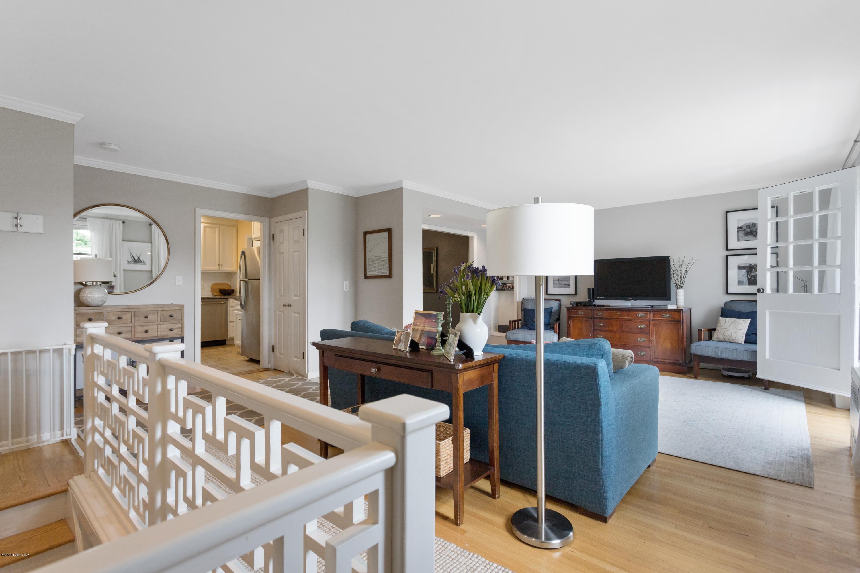 100 Putnam Park, Unit 100 Greenwich, CT 06830 - Photo 3 of 15 a living room with furniture a flat screen tv and wooden floor