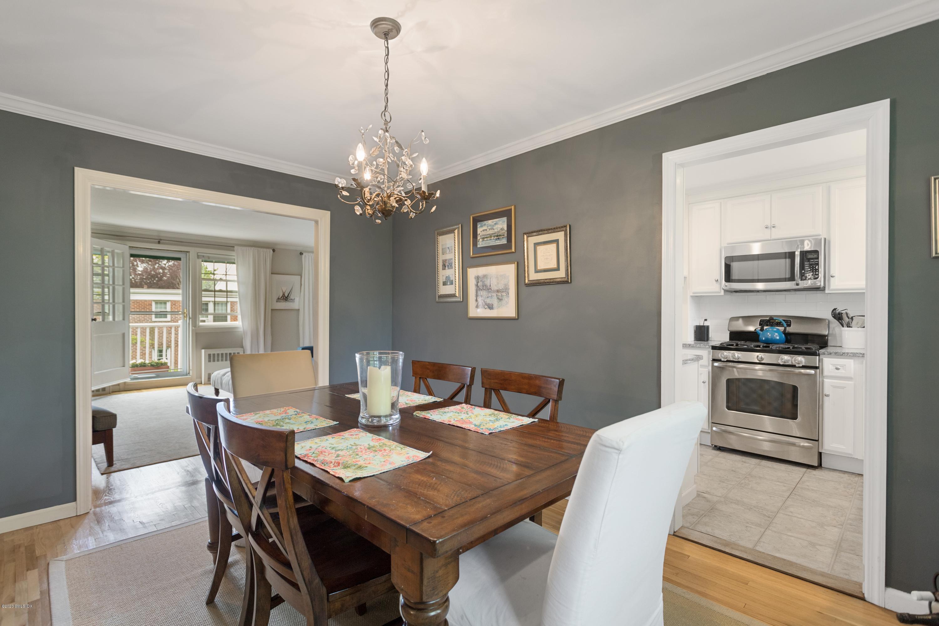 100 Putnam Park, Unit 100 Greenwich, CT 06830 - Photo 4 of 15 a view of a dining room with furniture and wooden floor