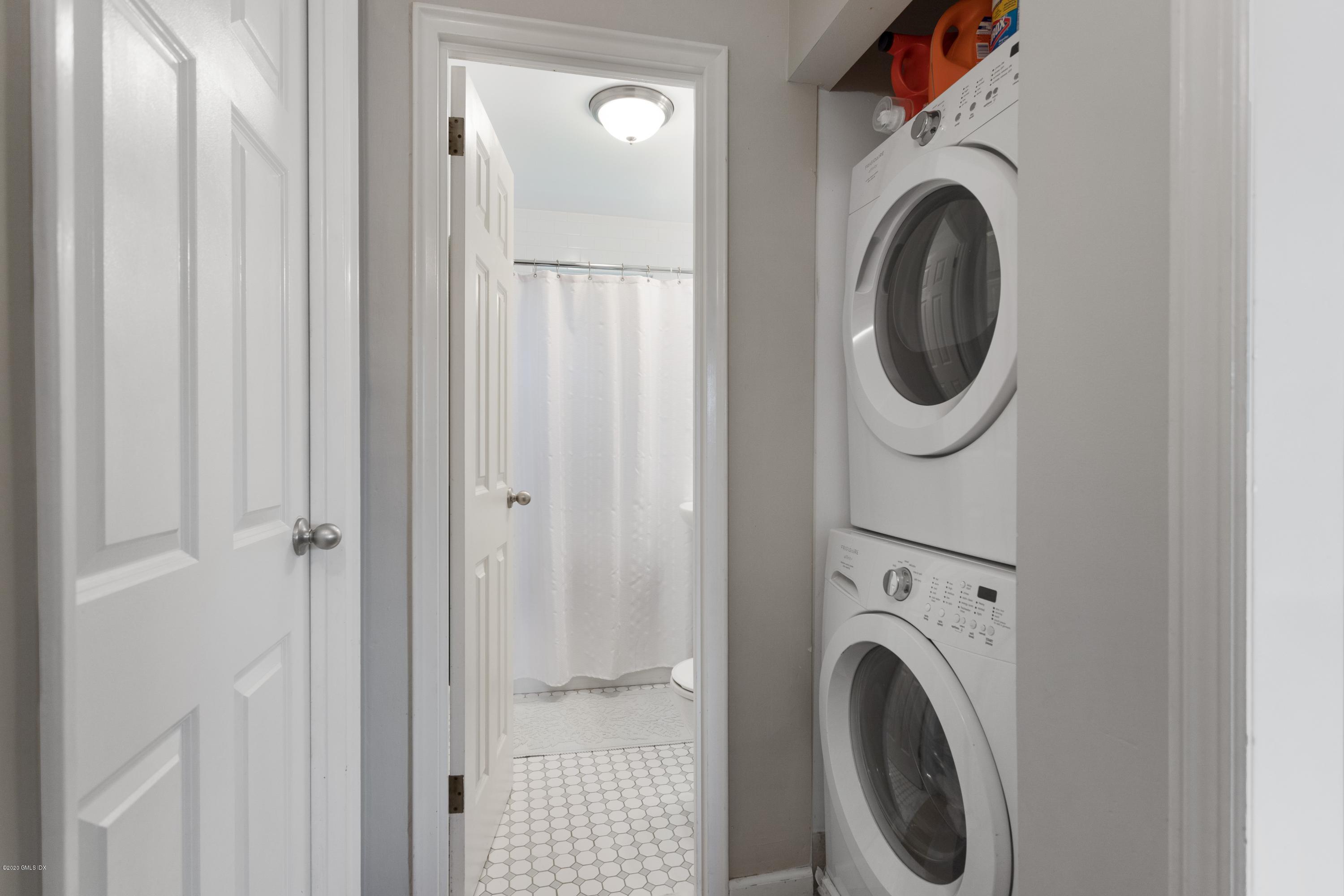 100 Putnam Park, Unit 100 Greenwich, CT 06830 - Photo 6 of 15 a view of a hallway with washer and dryer