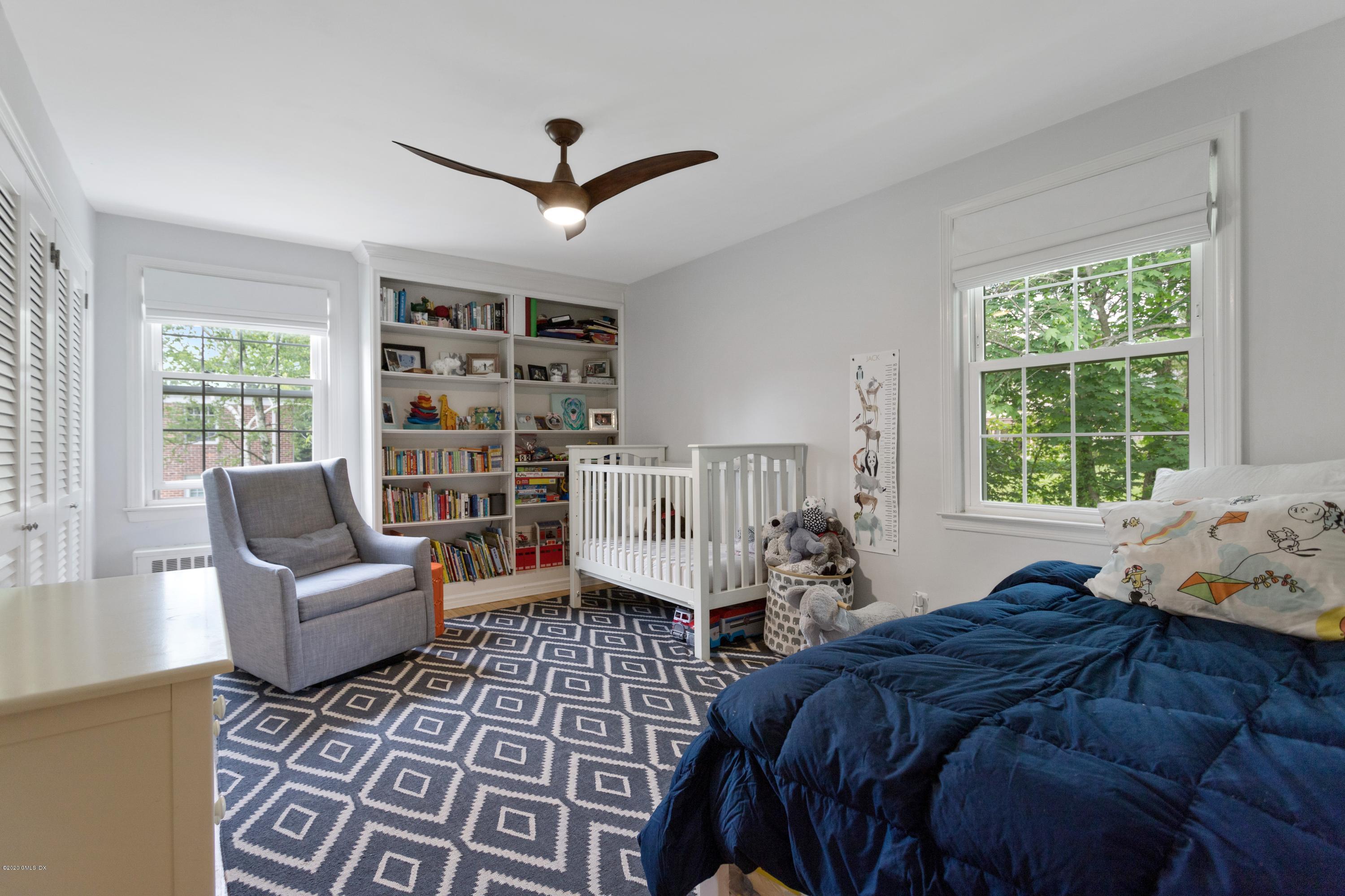 100 Putnam Park, Unit 100 Greenwich, CT 06830 - Photo 7 of 15 a bedroom with a bed furniture and a window