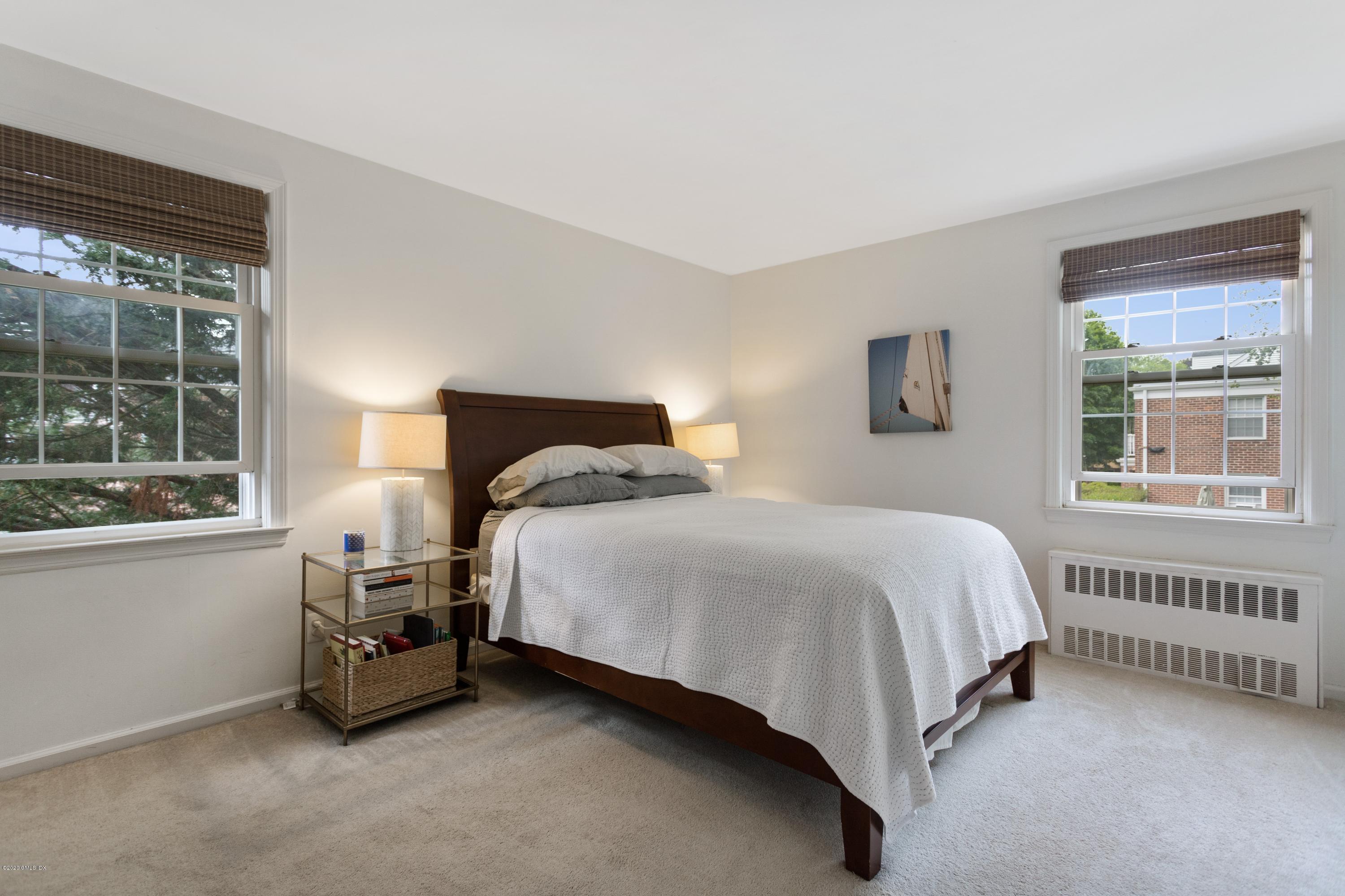 100 Putnam Park, Unit 100 Greenwich, CT 06830 - Photo 9 of 15 a bedroom with a bed and a window