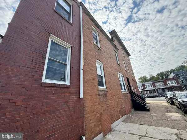 a view of a brick house with many windows