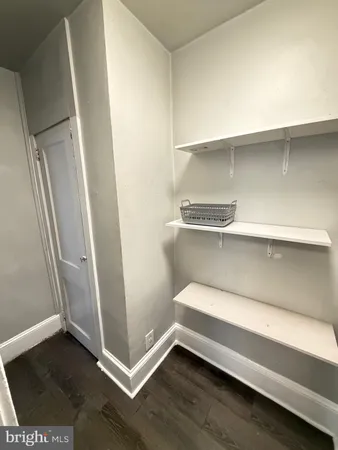 a view of walk in closet with empty racks