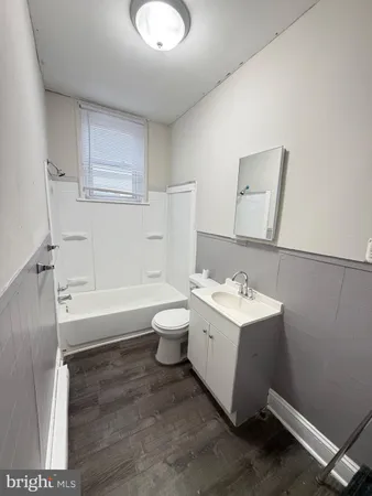 a bathroom with a sink a toilet and bathtub