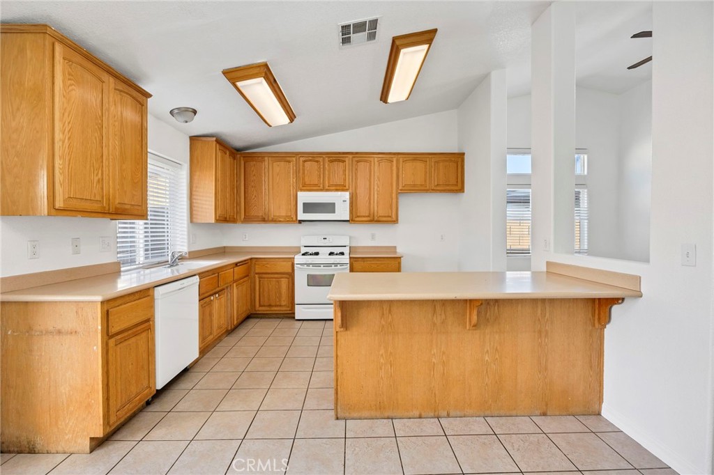 1230 Shellie Lane Hemet, CA 92543 - Photo 13 of 44 a large kitchen with stainless steel appliances granite countertop a sink and cabinets