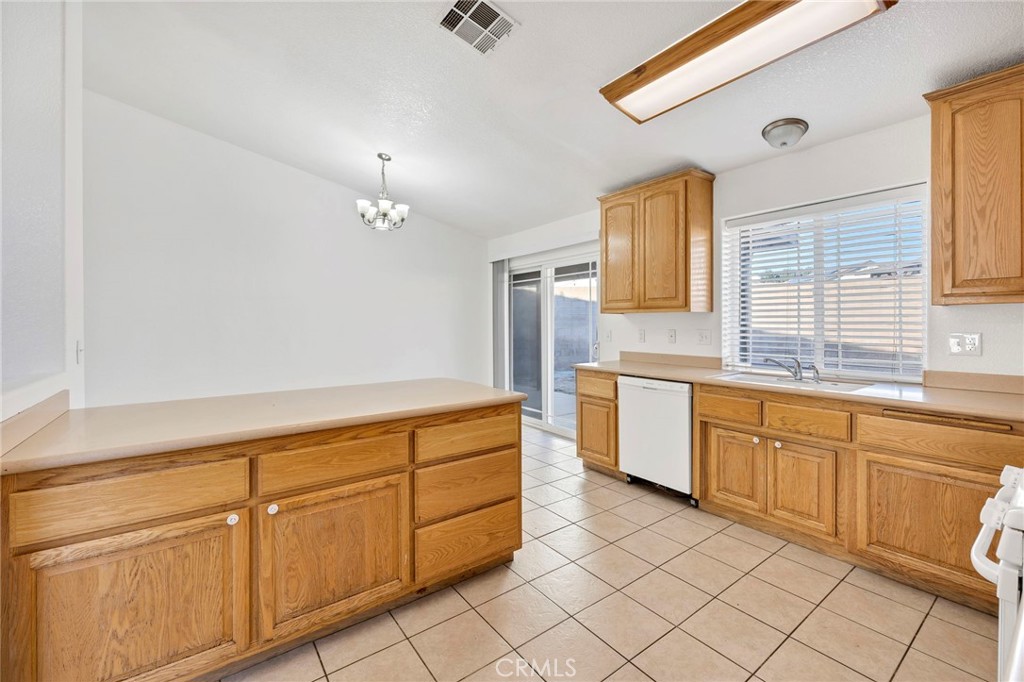 1230 Shellie Lane Hemet, CA 92543 - Photo 16 of 44 a kitchen with granite countertop white cabinets white appliances with a sink and dishwasher