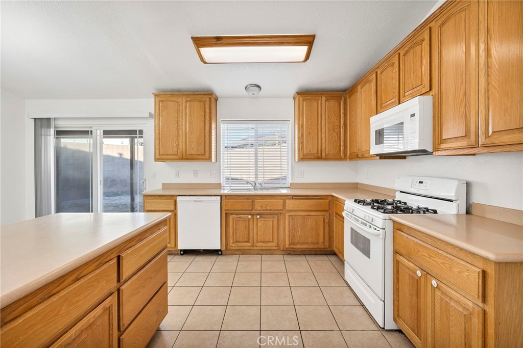 1230 Shellie Lane Hemet, CA 92543 - Photo 17 of 44 a kitchen with a sink stove and cabinets