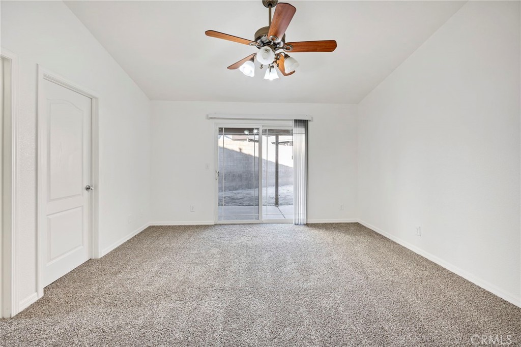 1230 Shellie Lane Hemet, CA 92543 - Photo 19 of 44 an empty room with windows and fan