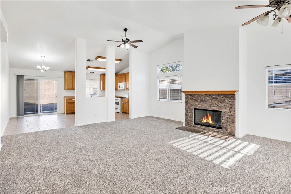 1230 Shellie Lane Hemet, CA 92543 - Photo 4 of 44 a view of a livingroom with a fireplace a chandelier and windows
