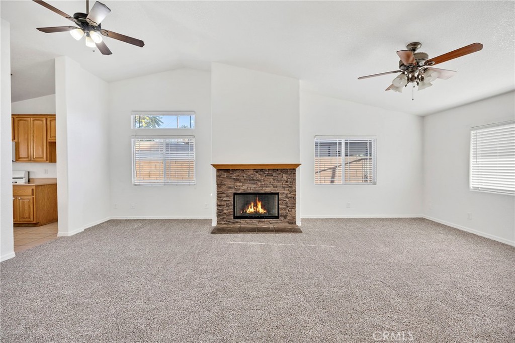 1230 Shellie Lane Hemet, CA 92543 - Photo 9 of 44 a view of an empty room with a fireplace and a window