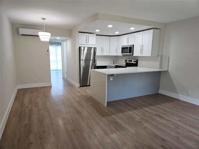 a kitchen with stainless steel appliances a refrigerator sink and microwave