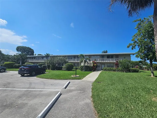 a view of a yard with table and chairs under an umbrella