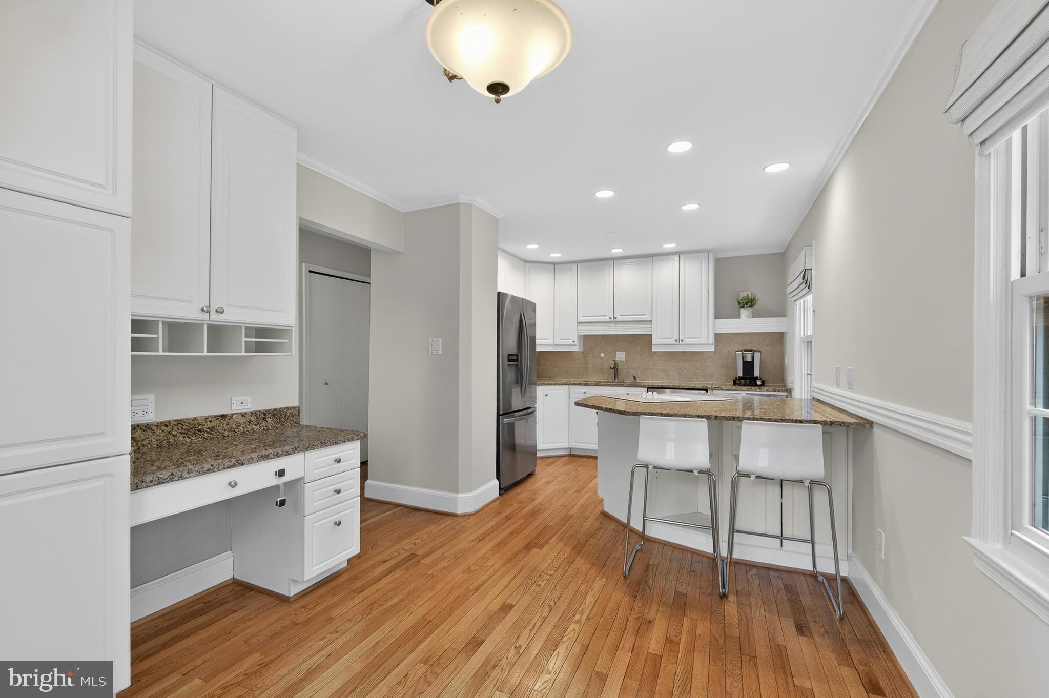 5624 Kirkham Court Springfield, VA 22151 - Photo 8 of 52 a kitchen with stainless steel appliances kitchen island granite countertop a wooden cabinets and counter space