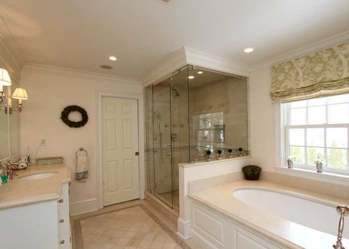 17 Dorchester Lane Riverside, CT 06878 - Photo 7 of 11 a bathroom with a sink a large mirror and shower