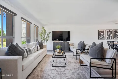 a living room with furniture and wooden floor