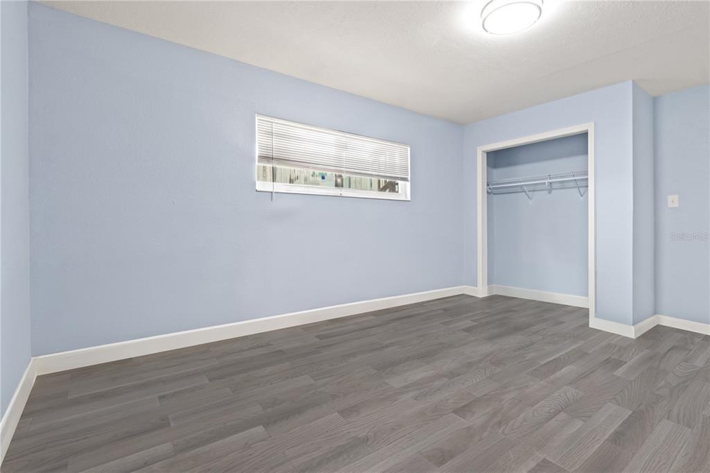 6515 Dimarco Road Tampa, FL 33634 - Photo 32 of 66 a view of an empty room with wooden floor
