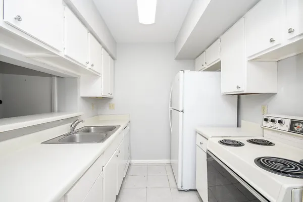 a kitchen with a sink a stove and refrigerator