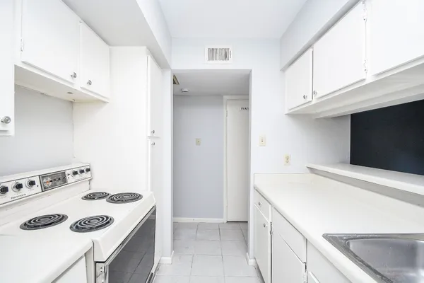 a kitchen with a stove and a refrigerator