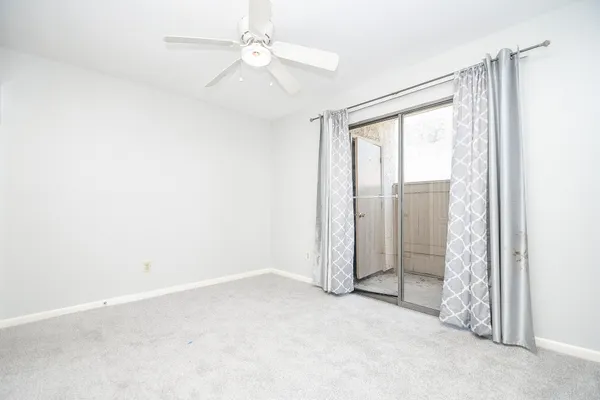 an empty room with a empty space and a ceiling fan
