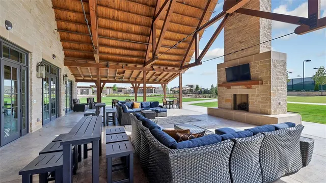 a living room with furniture a fireplace and a floor to ceiling window
