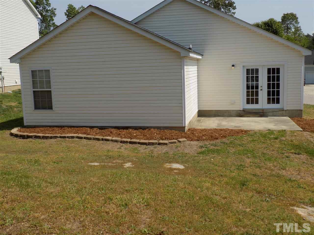 5401 Marthonna Way Raleigh, NC 27616 - Photo 11 of 12 a view of a house with backyard and garage