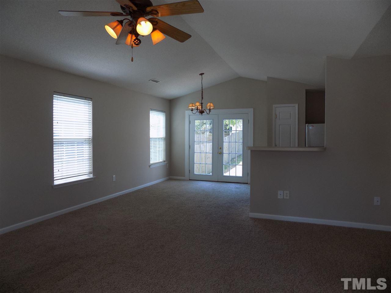 5401 Marthonna Way Raleigh, NC 27616 - Photo 3 of 12 a view of an empty room with window and chandelier fan