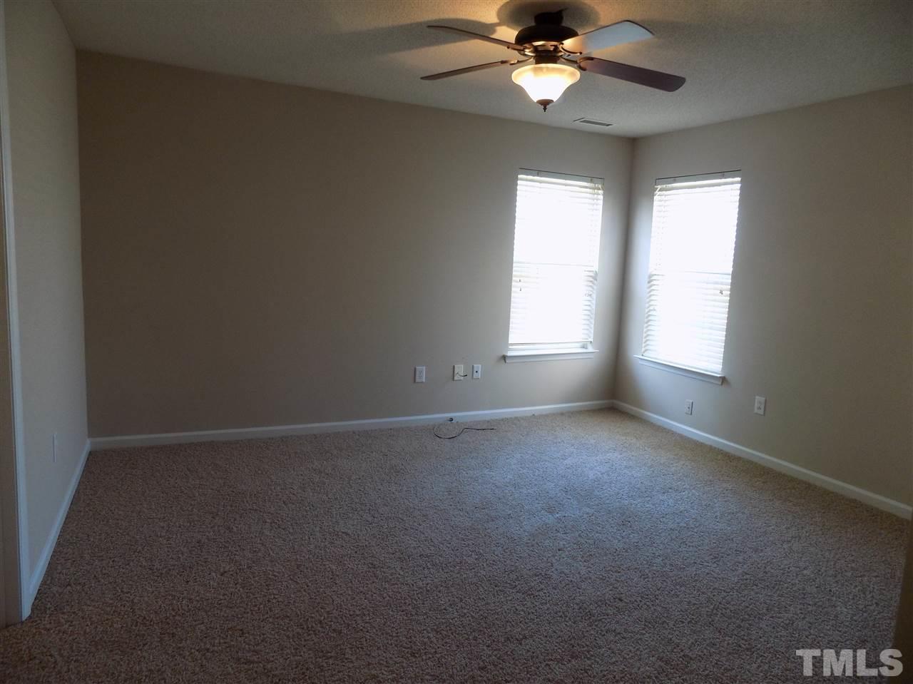 5401 Marthonna Way Raleigh, NC 27616 - Photo 10 of 12 an empty room with a window and a fan