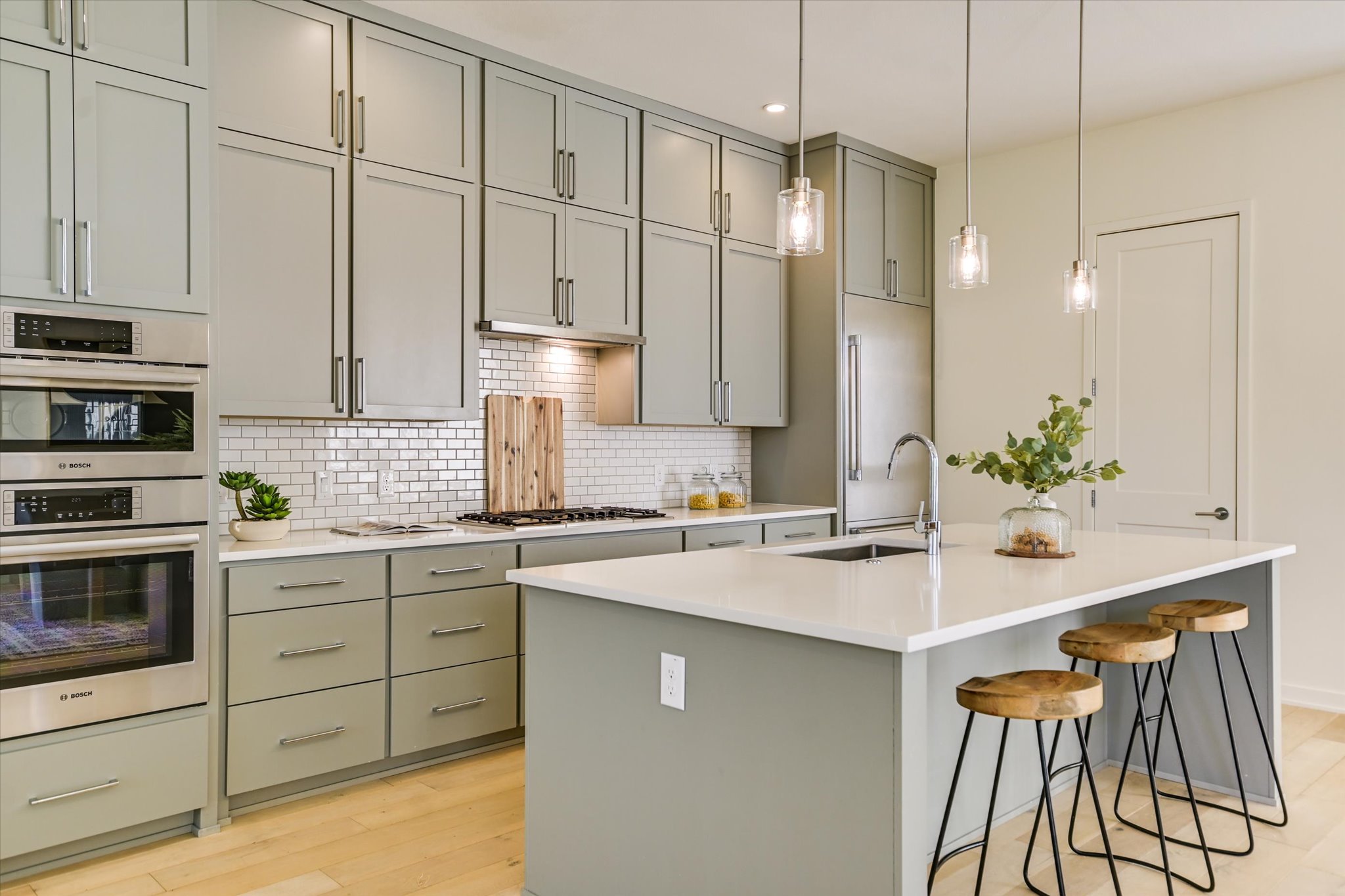 2610 Watkins Way Austin, TX 78746 - Photo 11 of 23 a kitchen with stainless steel appliances granite countertop a sink a stove and cabinets