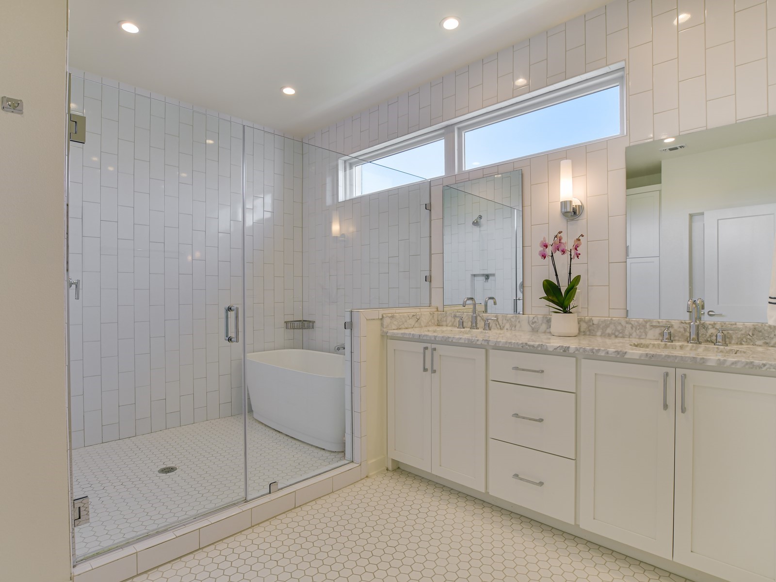 2610 Watkins Way Austin, TX 78746 - Photo 16 of 23 a bathroom with a shower sink and mirror