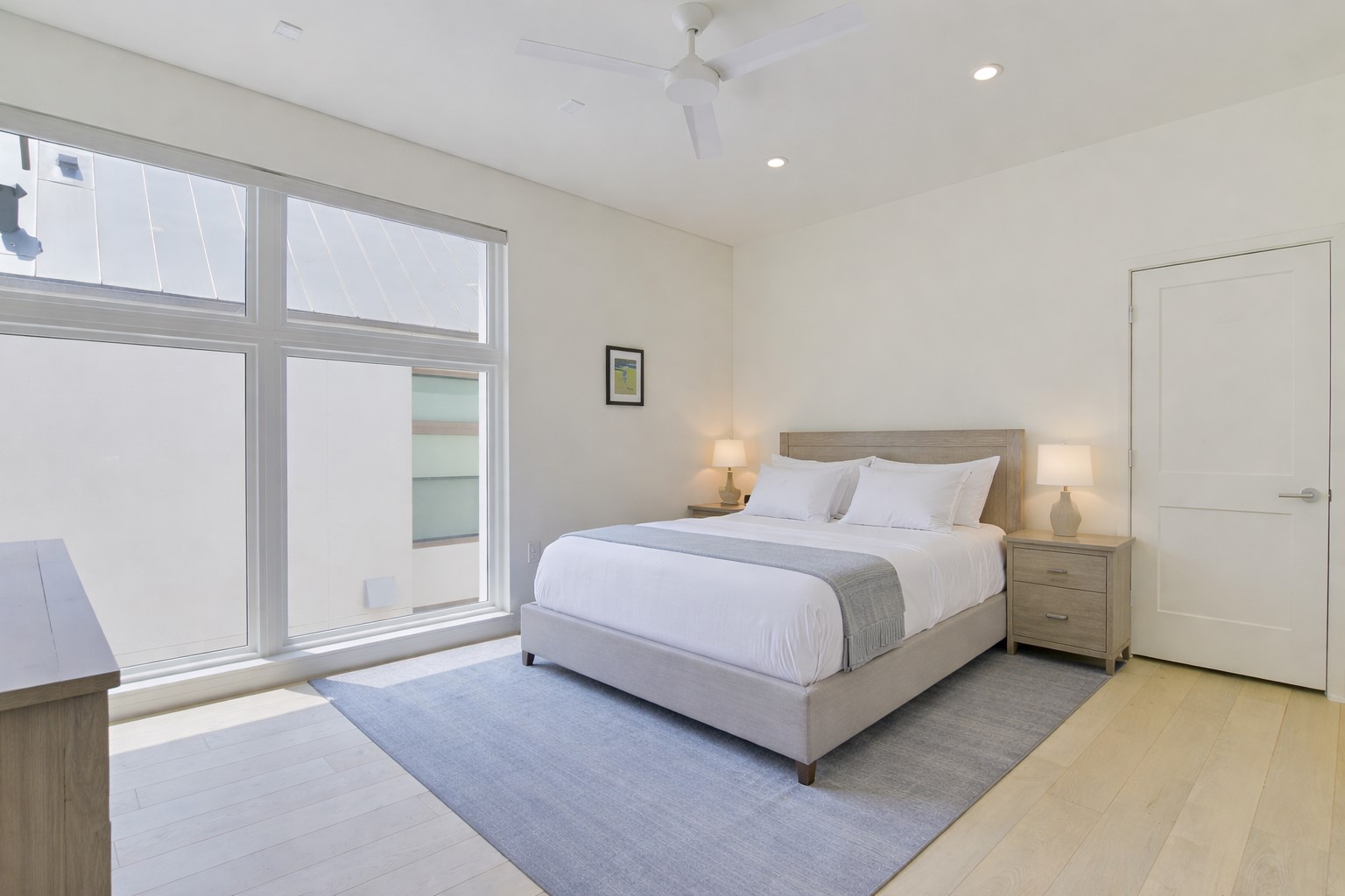 2610 Watkins Way Austin, TX 78746 - Photo 17 of 23 a spacious bedroom with a bed and a large window