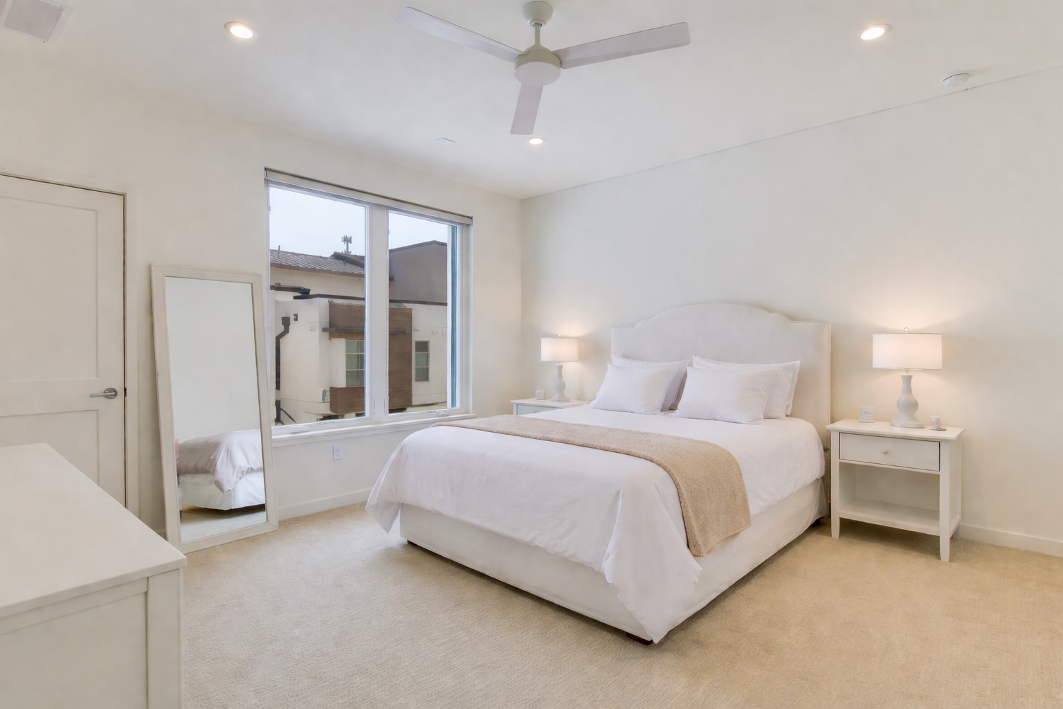 2610 Watkins Way Austin, TX 78746 - Photo 19 of 23 a bedroom with a large bed and a chandelier