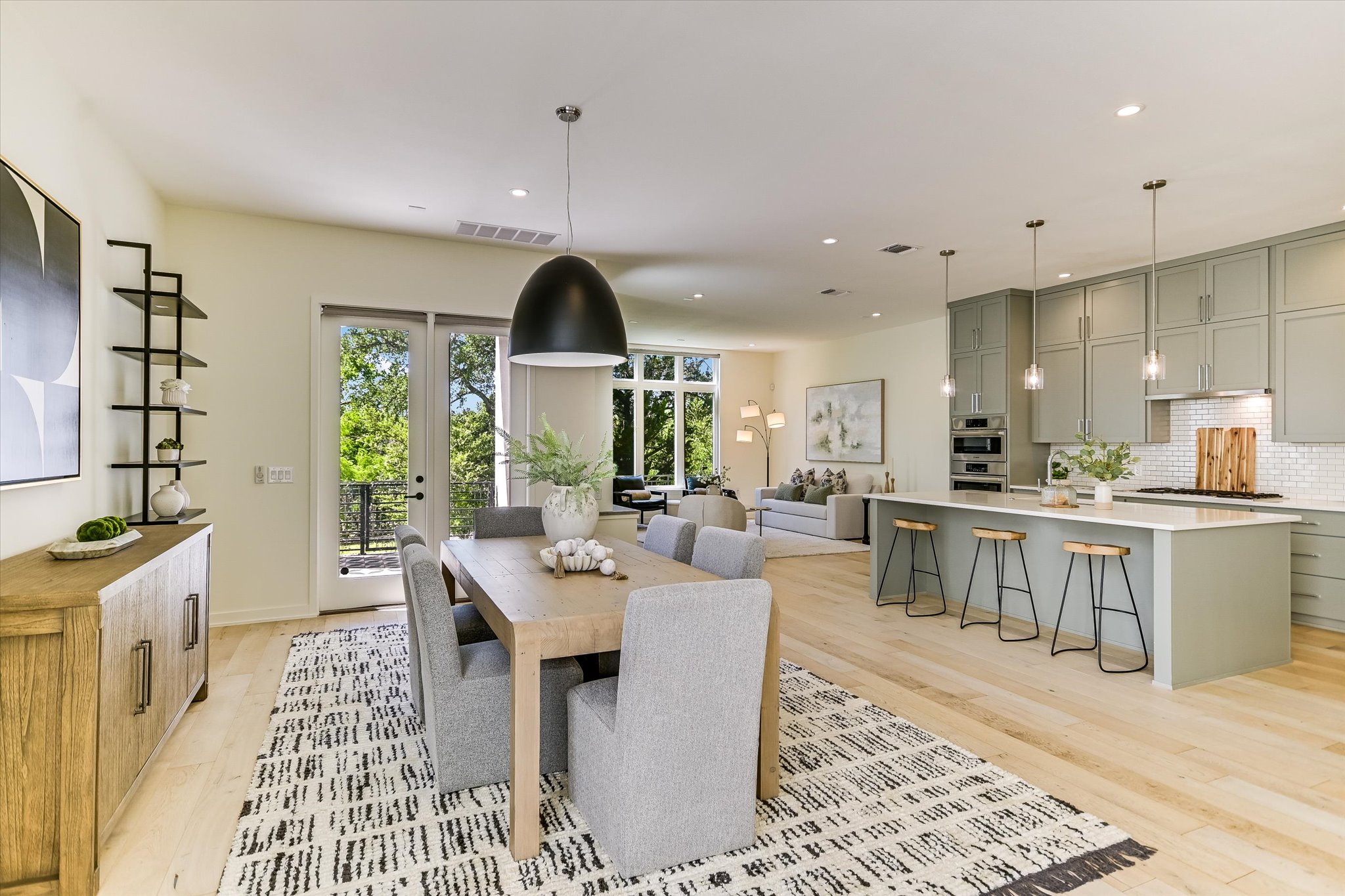 2610 Watkins Way Austin, TX 78746 - Photo 7 of 23 a living room with kitchen island furniture and a wooden floor