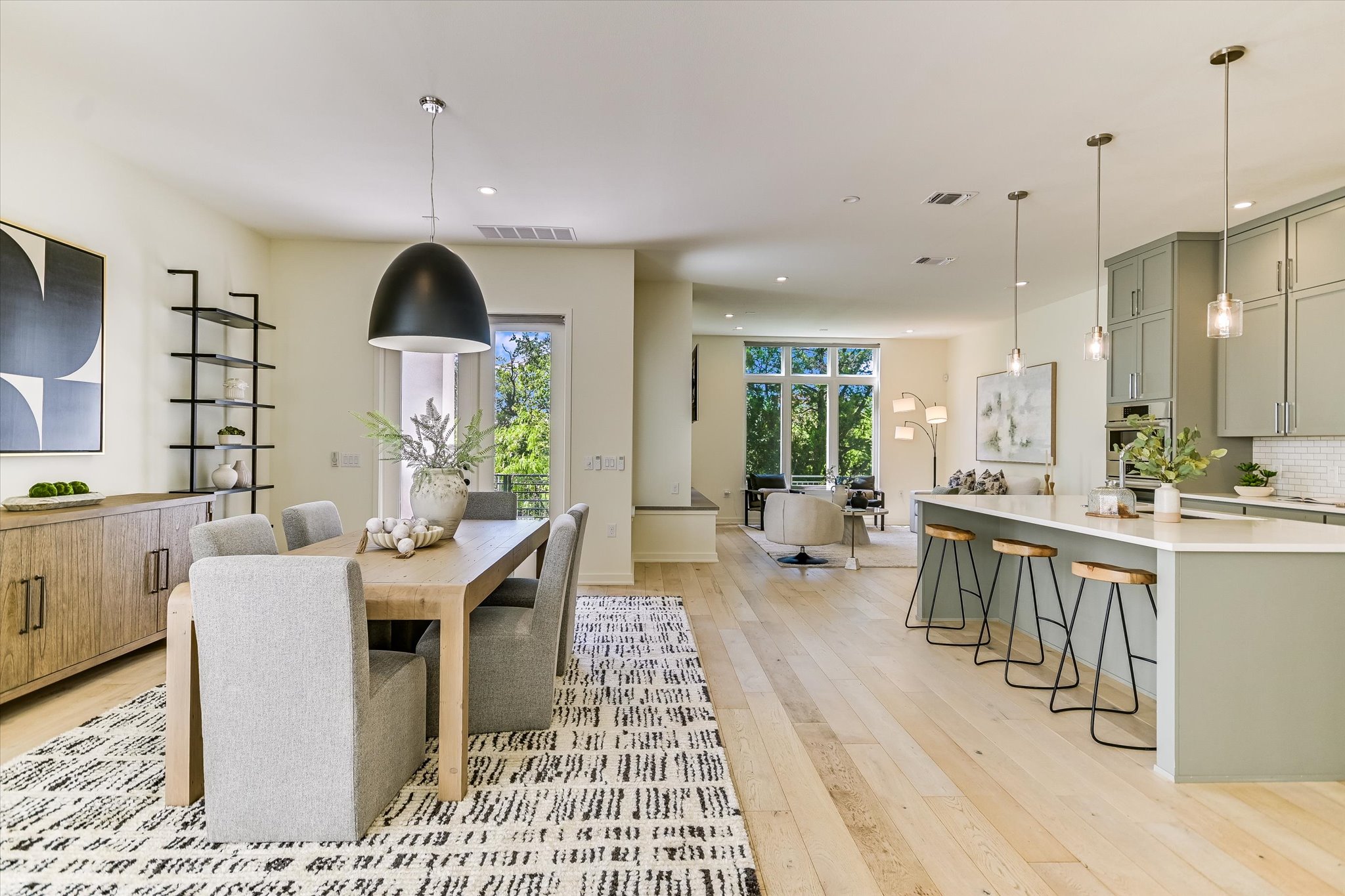 2610 Watkins Way Austin, TX 78746 - Photo 9 of 23 a large kitchen with kitchen island a white counter space a sink appliances and a dining table view