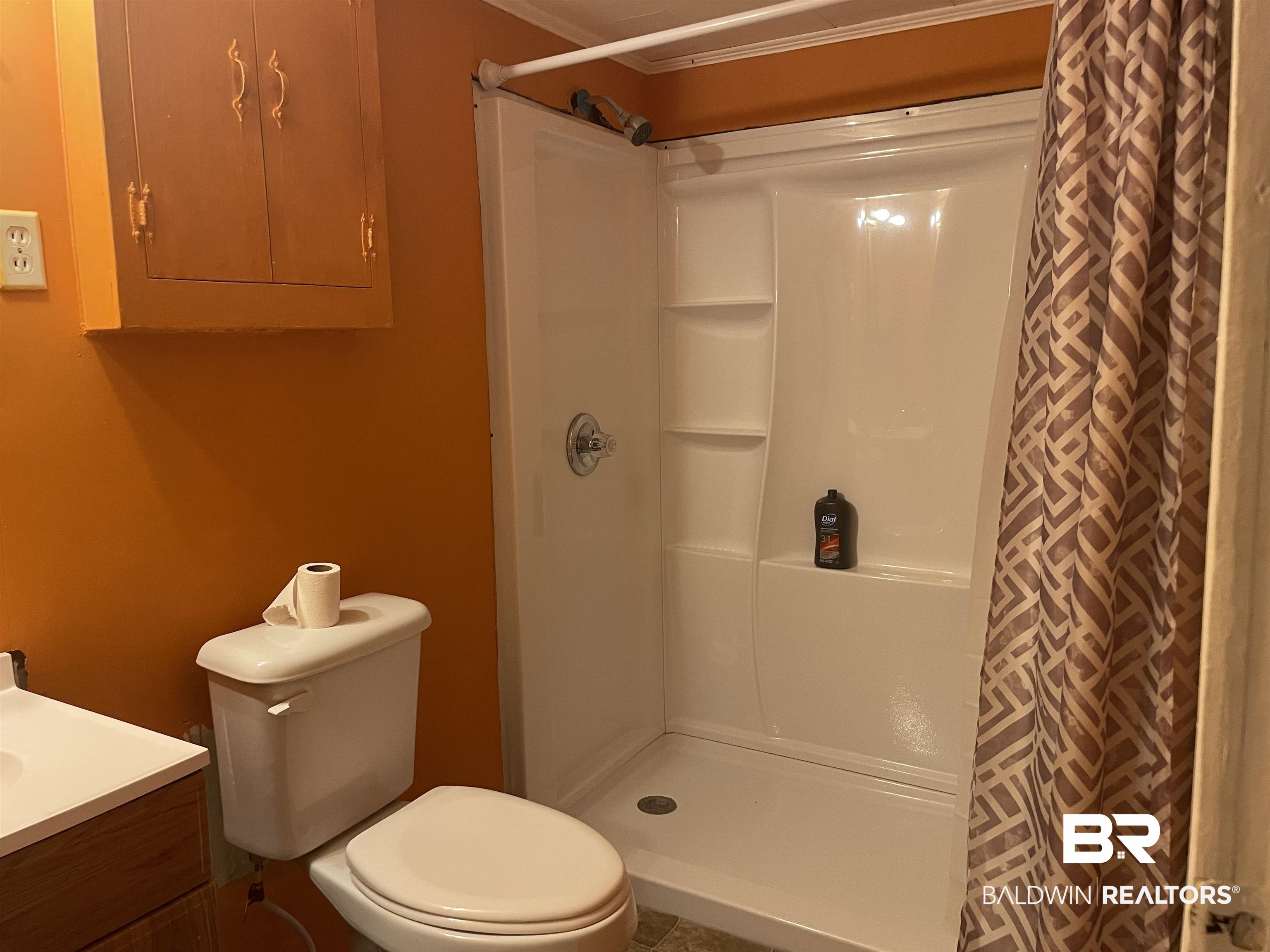 10673 Jack Springs Road Atmore, AL 36502 - Photo 10 of 14 Bathroom with vanity, toilet, electric panel, and walk in shower