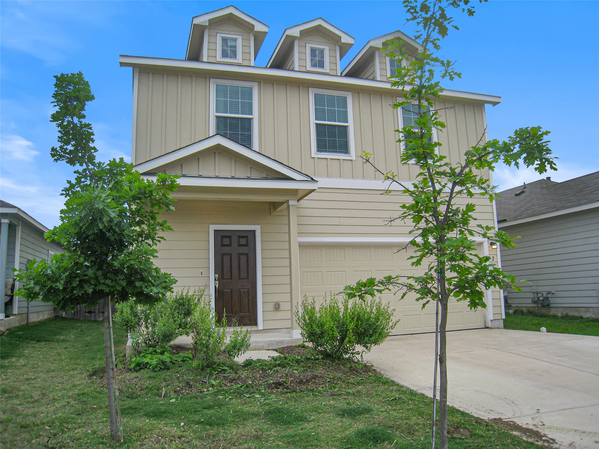 229 Geode Glen Maxwell, TX 78656 - Photo 2 of 19 Two-story home features a welcoming front entry, attached garage, and dormer windows.