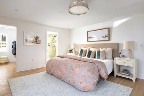 a spacious bedroom with a bed and a couch