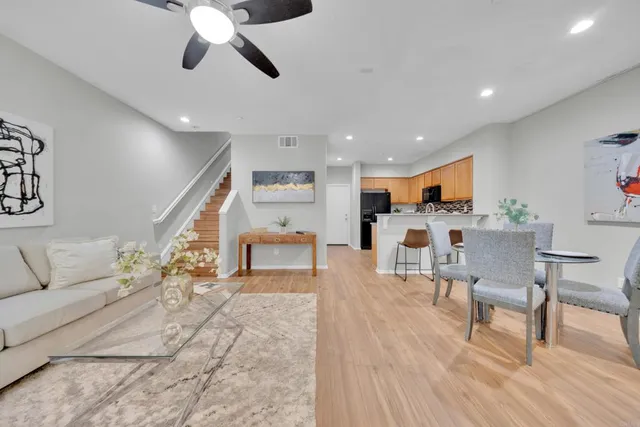 a living room with furniture and kitchen view