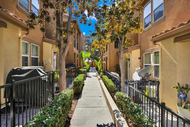 a view of a pathway that has the both side of house