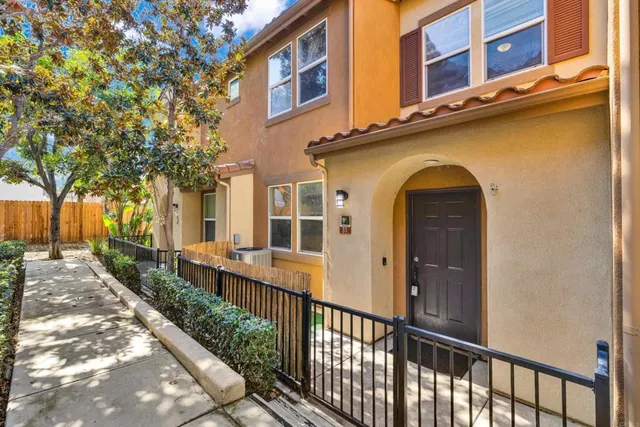 a view of a brick house with large windows