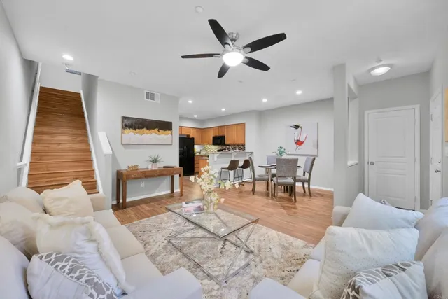 a living room with furniture and kitchen view