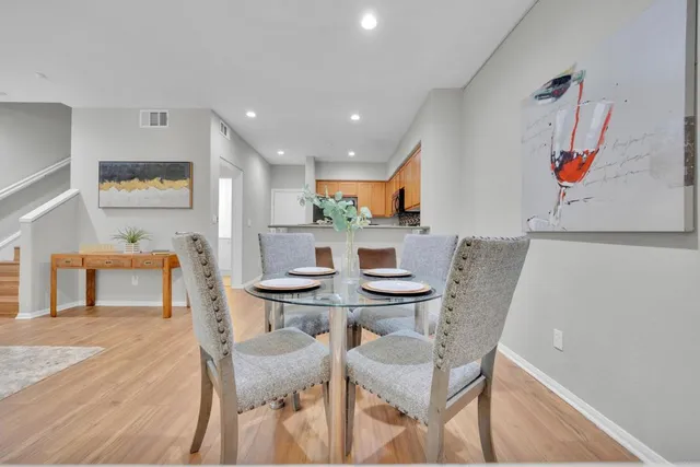 a view of a dining room with furniture and wooden floor