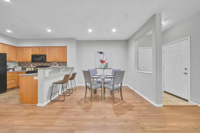 a view of a dining room with furniture and a wooden floor