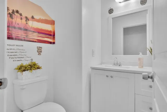 a bathroom with a toilet sink and mirror
